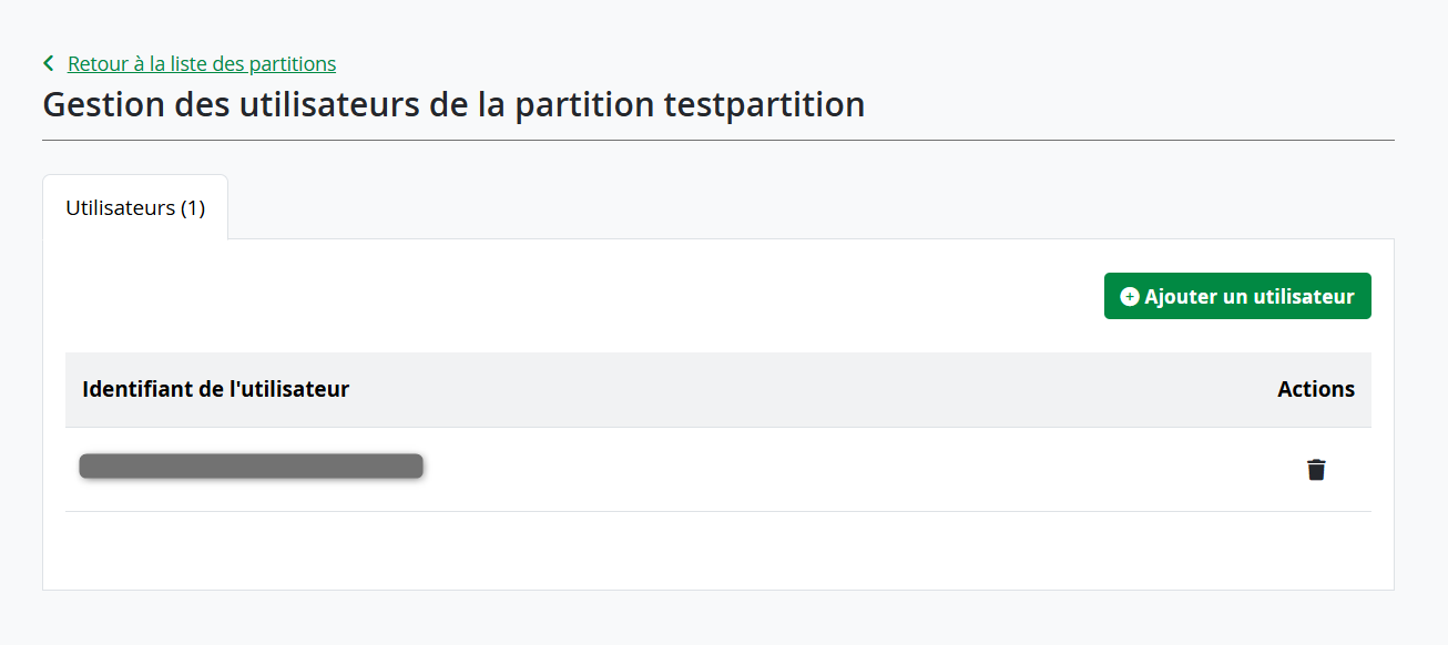 User management interface for a partition " showing a table with one user listed under "User ID" and an action column with a delete icon. The interface includes a green button labeled "Add a user" and navigation link to return to the list of partitions.
